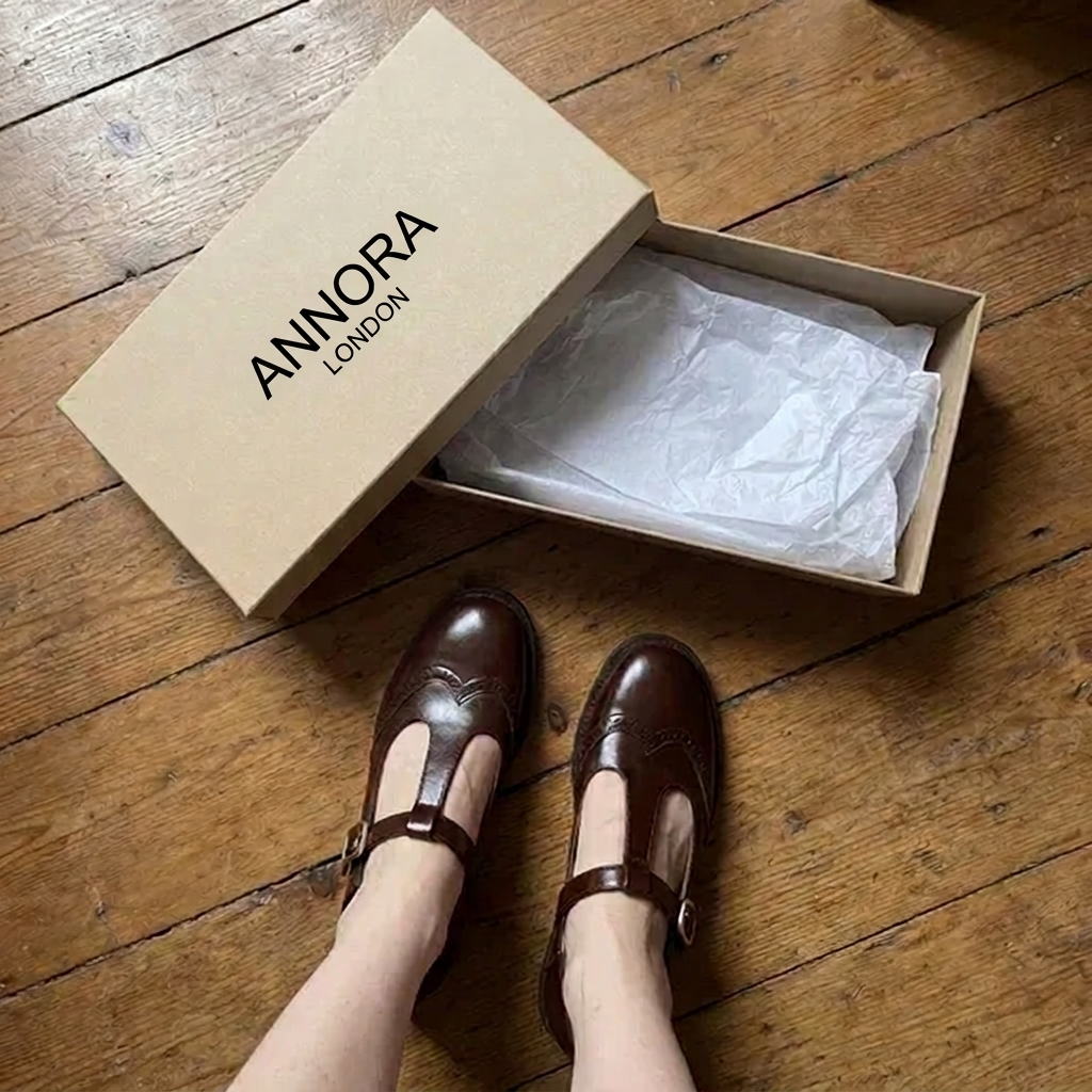 Feet in brown T-bar Mary Janes next to the open ANNORA LONDON box